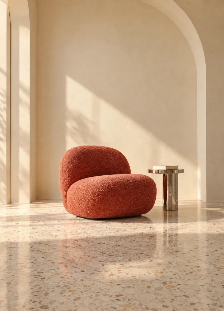Coral lounge chair in a sunlit arched reading nook